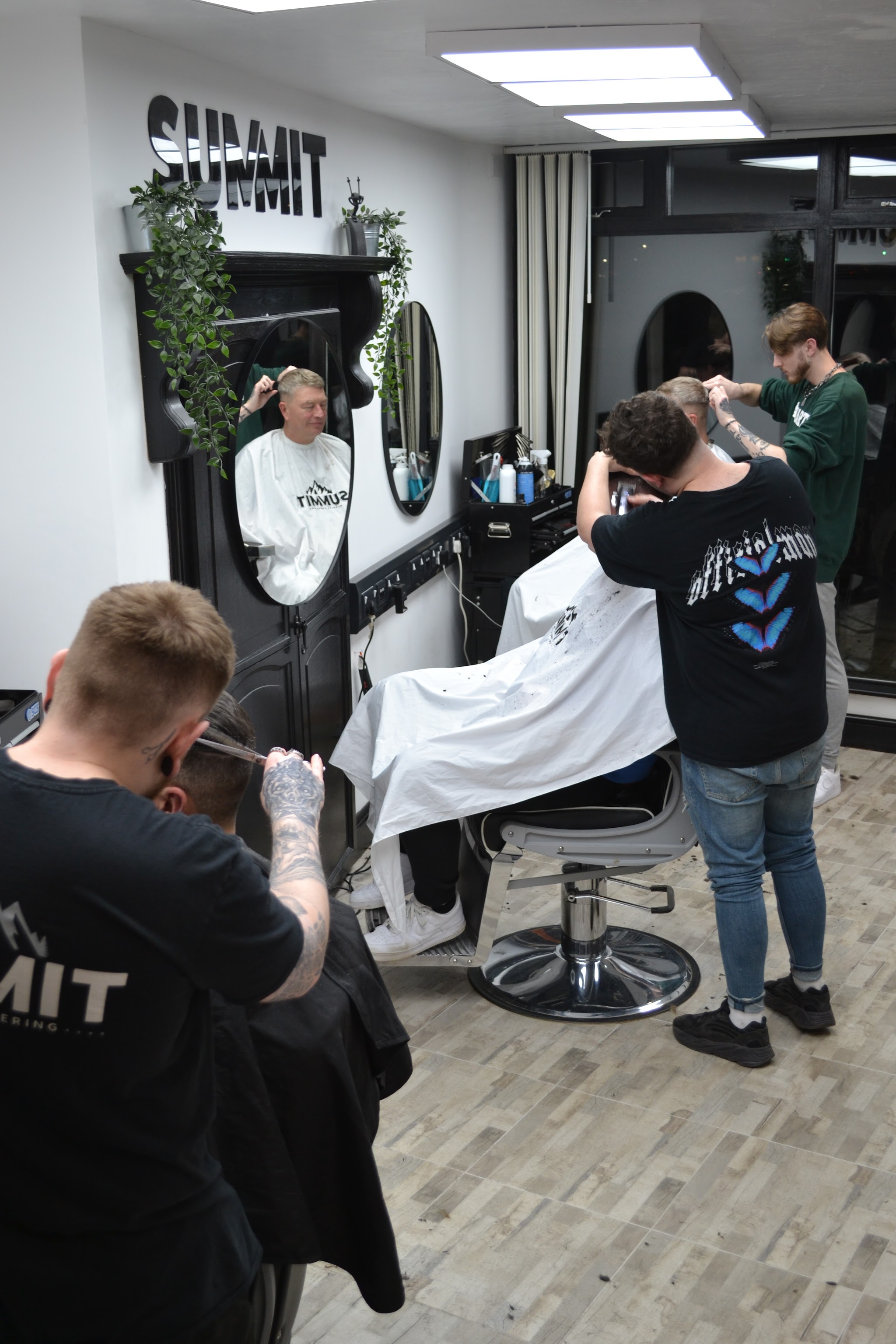 Two Summit barbers cutting side by side in the shop