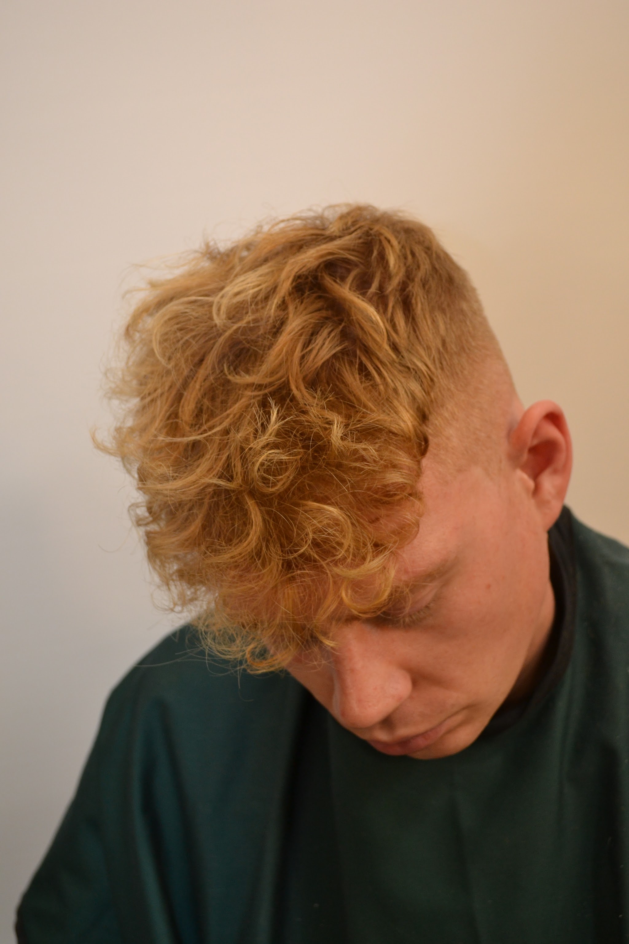 Curly top with a tight fade on the sides